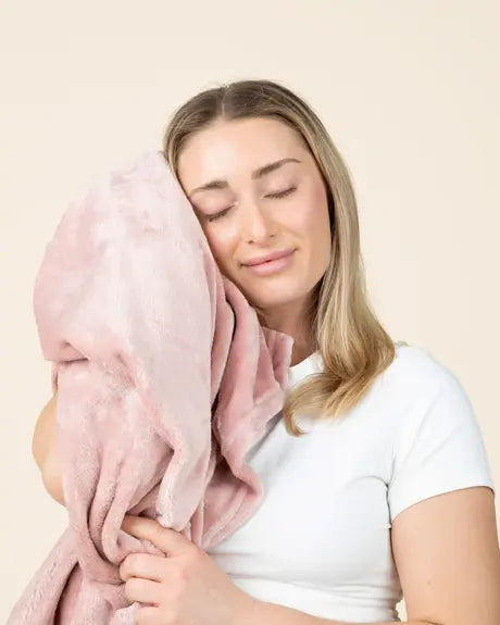 Creator hugging the blush EverSnug blanket