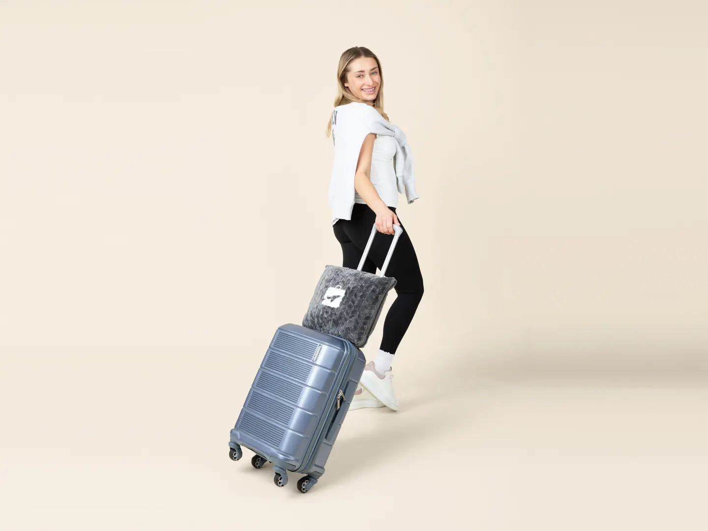 An EverSnug travel pillow carried beside luggage
